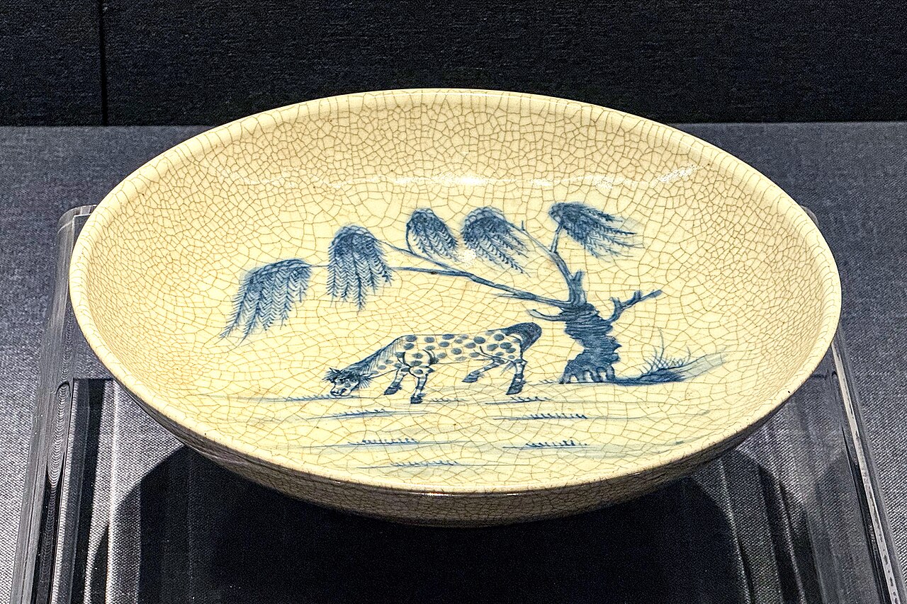 Blue-and-white plate painted with a willow tree and a horse
